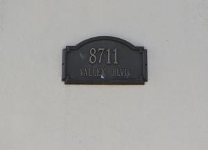 a sign on the side of a wall at Valley Hotel in Rosemead