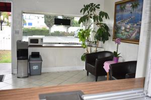 a restaurant with a counter with chairs and a table at Valley Hotel in Rosemead