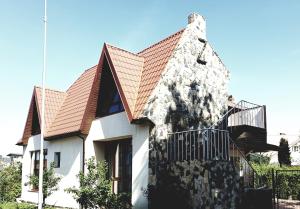 a white house with a red roof at Vila G Palanga in Palanga