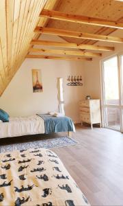 a bedroom with a bed and a wooden ceiling at Vila G Palanga in Palanga