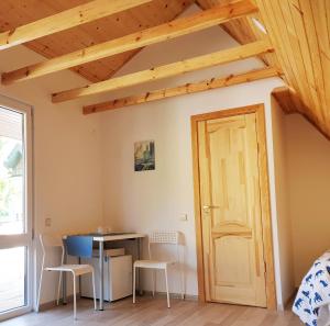 a room with a table and chairs and a door at Vila G Palanga in Palanga