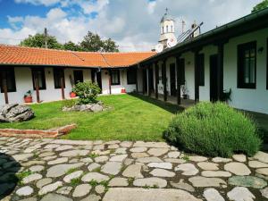 a courtyard of a building with a clock tower at Комплекс ВАЛЕРА in Gabarevo