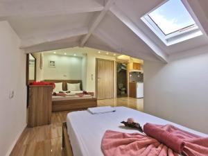 a bedroom with a bed and a skylight at Apartments Kidonis in Limenaria