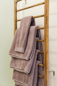 a bunch of towels on a towel rack at Espace Couronne by Hébergements DCL in Quebec City