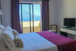 Кровать или кровати в номере Hotel Horta
