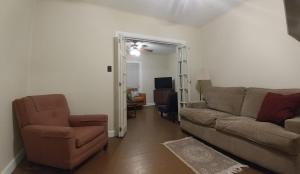 a living room with a couch and a chair at Aunt Jane's Yellow House in Put-in-Bay