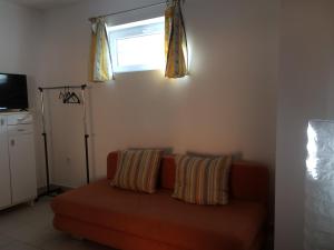 a living room with a couch and a window at Teraszos ház in Balatonlelle