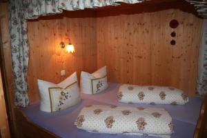 a bedroom with a bed with pillows on it at Ferienhaus Schnetzer in Sankt Gallenkirch