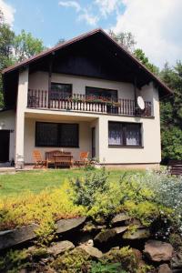 a house with a table and chairs in front of it at Spacious house at the gate of Giant Mountains in Víchová nad Jizerou