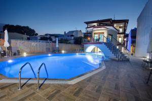 a swimming pool in front of a house at Rent House Karavi in Iraklitsa