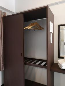 a closet with an open door with an umbrella at RoongThoeng Place Hotel in Thoeng