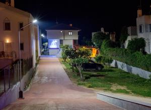 a street at night with a house and a car at Rent House Karavi in Iraklitsa