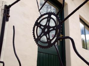 a wrought iron door sign on a building at Aandster in Nieu-Bethesda