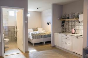 a bedroom with a bed and a bathroom with a sink at Saga Studios by Heimaleiga in Reykjavík +63 photos