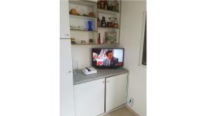 a kitchen with a counter with a tv on it at Résidence Belle Vue des îles in Sainte-Anne