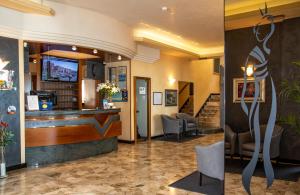 a lobby of a hotel with a bar and chairs at Hotel Sayonara in Lido di Jesolo