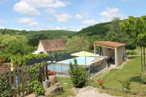 a villa with a swimming pool and a house at A l'Oree des Cazelles in Saint-Pierre-Toirac