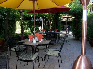 an outdoor patio with tables and chairs with umbrellas at The Inn on First in Napa