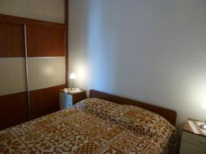 a hotel room with a bed and two night stands at LAVANDA OMIŠALJ in Omišalj