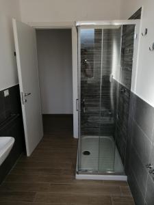 a bathroom with a shower with a glass door at Appartamento fronte mare in Porto Recanati