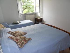 Letto o letti in una camera di B&B L'uva Fragolina