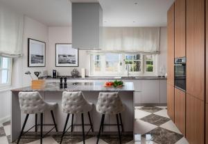 a kitchen with a island with two stools at Villa Ivana in Vabriga