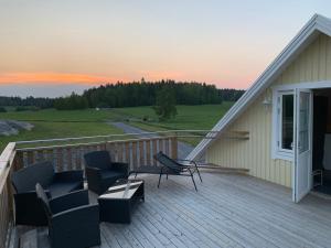 a deck with chairs and a table on a house at Lyckebo in Malmköping