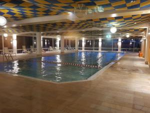 a large swimming pool with blue and yellow ceiling at Alpentraum in Scheidegg