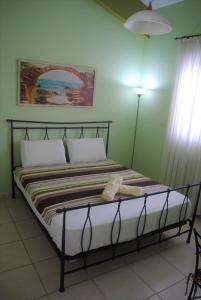 a bed in a green room with at Villa Lachi in Polis Chrysochous +20 photos