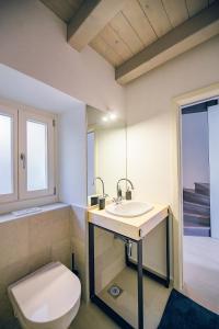 a bathroom with a toilet and a sink at Casa Salita Garibaldi in Opatija