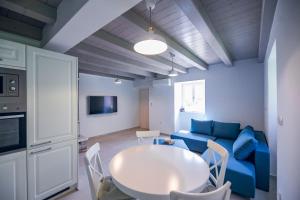 a living room with a blue couch and a table at Casa Salita Garibaldi in Opatija
