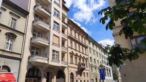 a tall white building with balconies on a street at Million dollar view from the balcony in Budapest