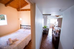 a bedroom with a bed and a dining room at Agios Andreas Beach Villas in Áyios Andréas Messinias