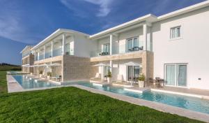 a large white building with a swimming pool at Senator Puerto Plata in San Felipe de Puerto Plata +51 photos