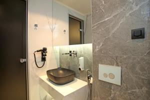a bathroom with a bowl sink and a mirror at Athinais Luxury Apartments in Hanioti