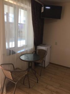a room with a table and chairs and a window at Mirage Hotel in Zatoka