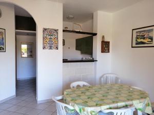 a kitchen and dining room with a table and chairs at Casa Esperanto in Favignana +7 photos