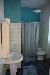 a bathroom with a white sink and a toilet at Alloggio turistico Monte Santa Maria in Poggio Nativo