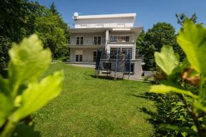 a house on a hill with green grass in front of it at Sweet Secret in Samobor