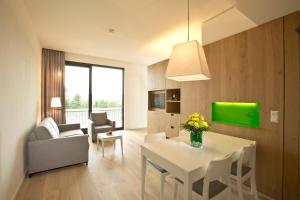 a living room with a white table and a couch at Hotel Kloster Haydau in Morschen