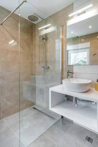 a bathroom with a sink and a glass shower at Apartments Mijo in Dugi Rat +44 photos