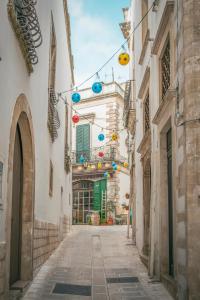 an alley in an old town with colorful lights at La pietra Maga in Martina Franca