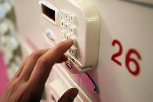 a person pressing a button on an alarm clock at Jugendherberge-Berlin-International in Berlin