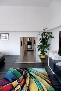 a living room with a colorful rug on the floor at Main Square Oval Apartment in Zagreb