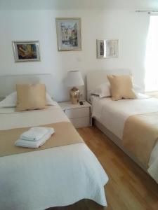 two beds sitting next to each other in a bedroom at Private Apartments In Diocletians Palace in Split