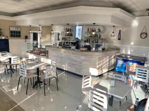 a restaurant with tables and chairs and a bar at Alojamento Restaurante Dom Dinis in Vila Nova de Poiares