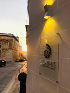 a sign on the side of a building at Nautilus Boutique Townhouse in Sliema