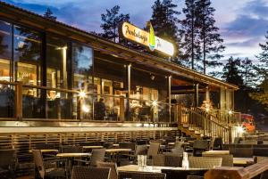 a restaurant with tables and chairs at night at Pankkotupa Yrjo in Punkaharju