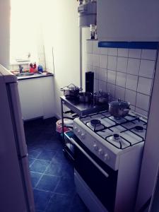 a kitchen with a stove with pots and pans on it at Cosy room in sydhavn in Copenhagen