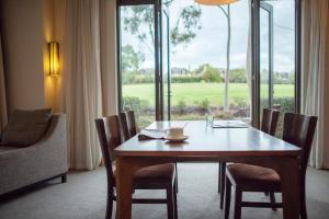 a dining room with a table and chairs and a window at Yarra Valley Lodge in Wonga Park